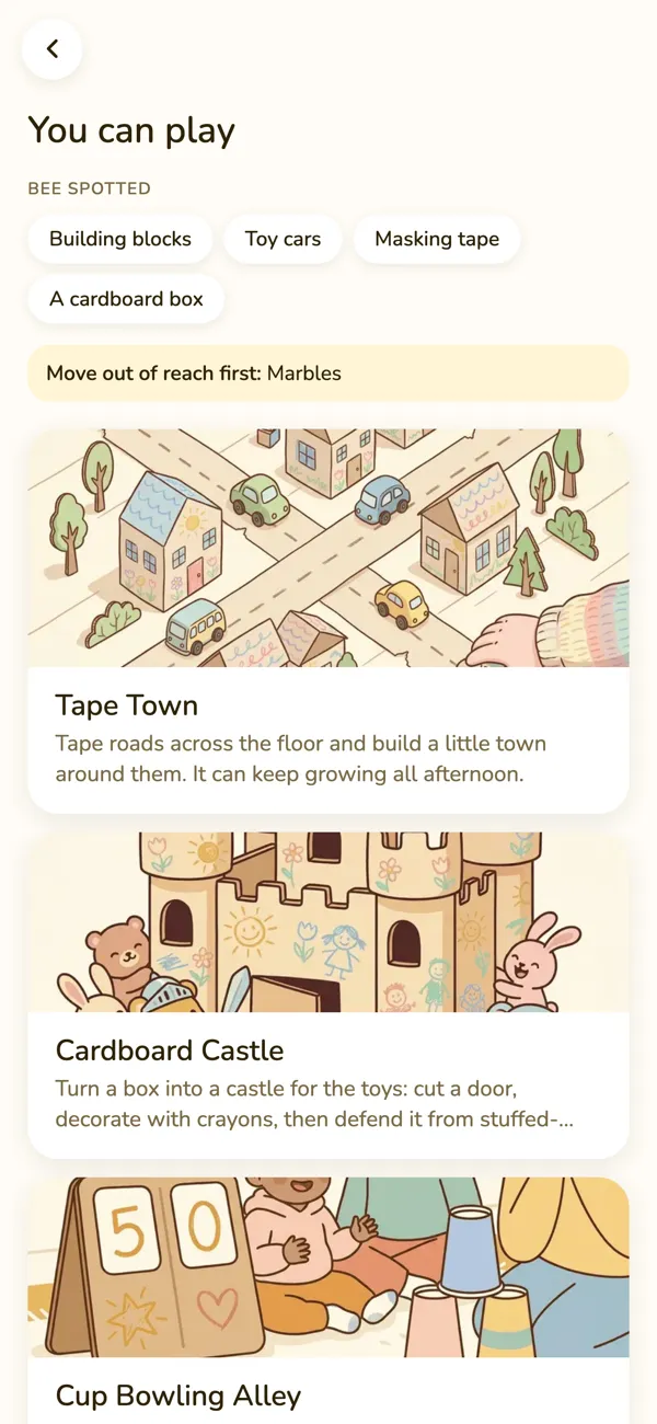 The app's photo result: Bee spotted building blocks, toy cars, masking tape and a cardboard box, says to move the marbles out of reach, and offers Tape Town, Cardboard Castle and Cup Bowling Alley.